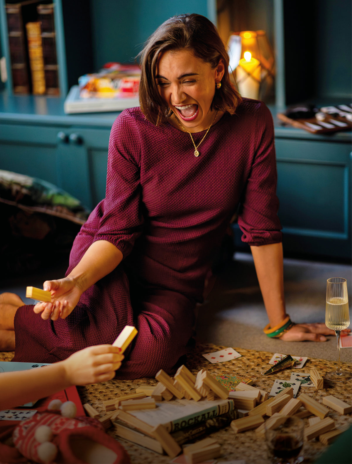 Women in burgundy dress playing games - shop burgundy edits