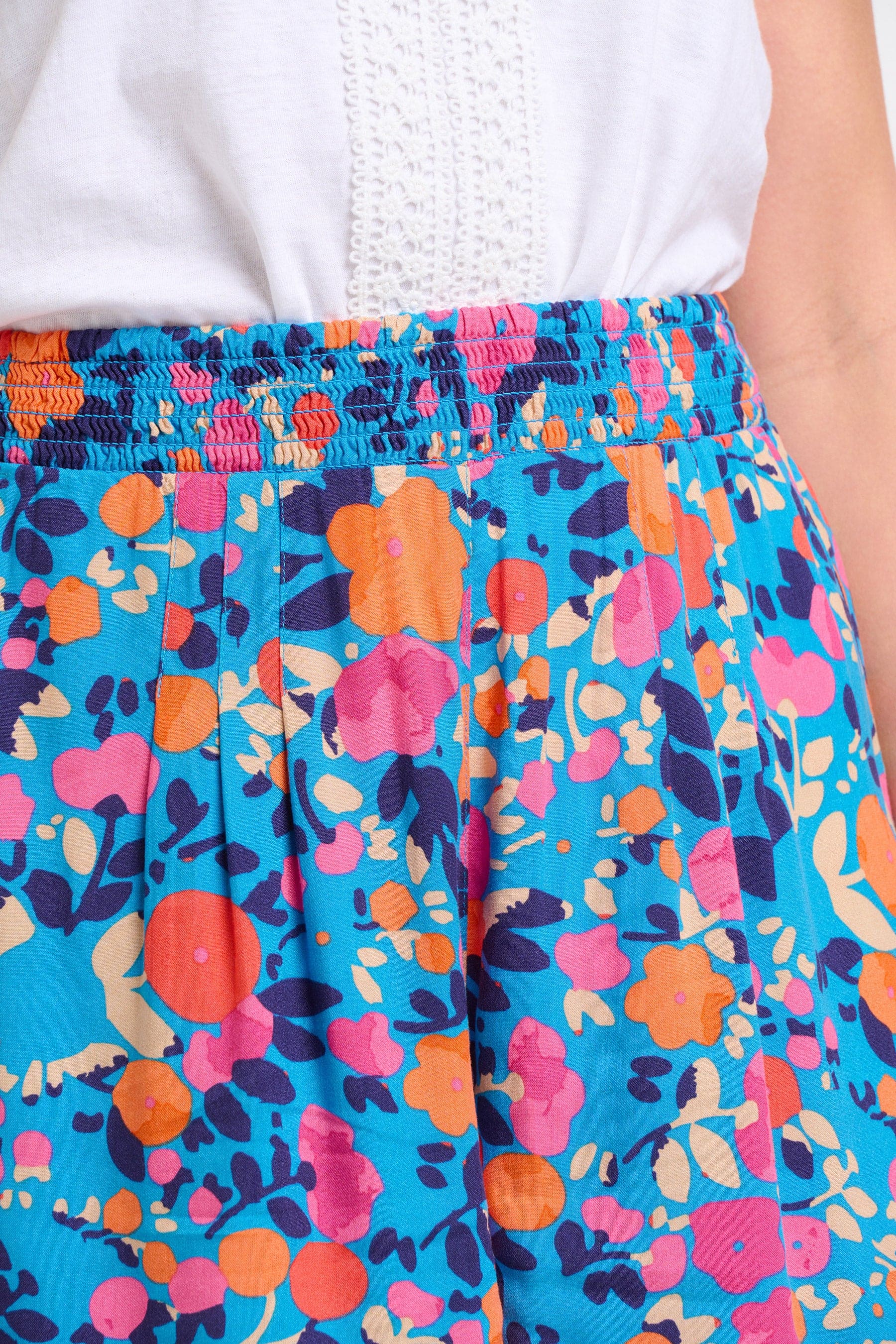 Close up of the women's bloom floral shorts. Blue, pink and orange floral patterns.